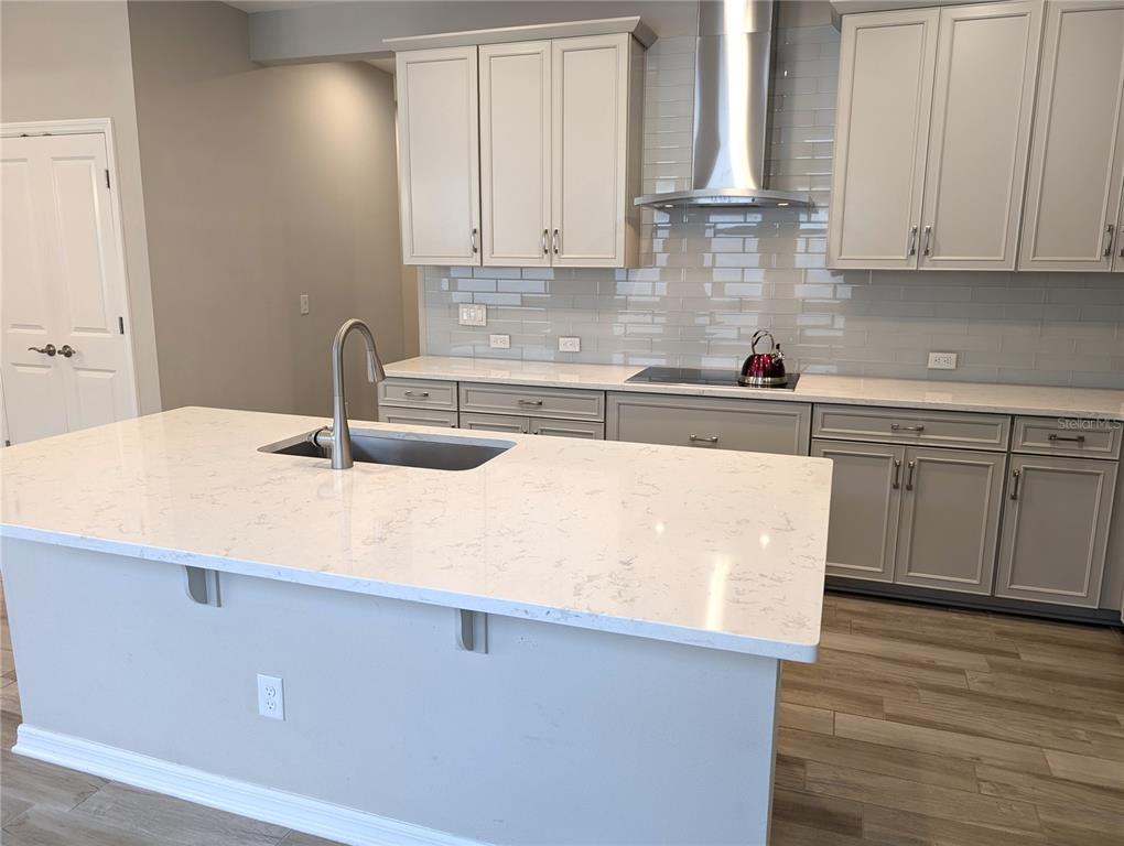 8545 Cache Drive Sarasota, FL 34240 - Photo 7 of 38 a kitchen with a sink cabinets and wooden floor