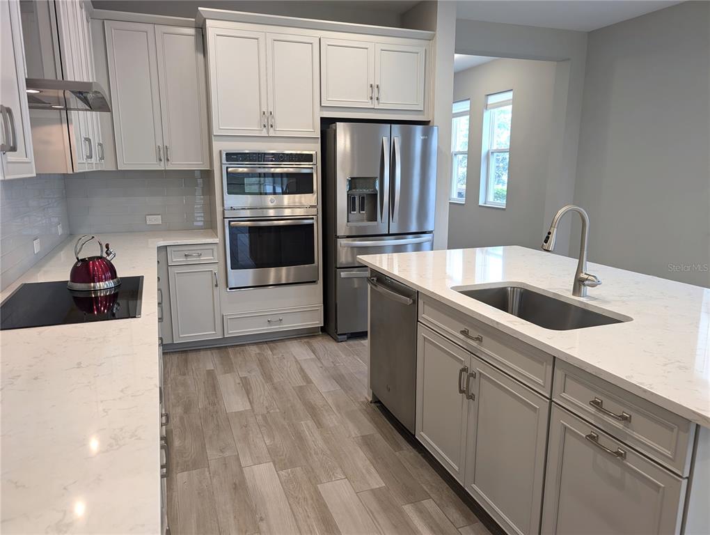 8545 Cache Drive Sarasota, FL 34240 - Photo 10 of 38 a kitchen with stainless steel appliances granite countertop a refrigerator sink and stove