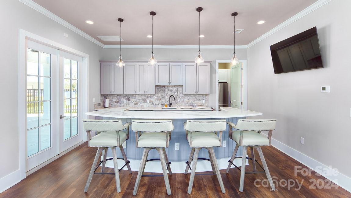 537 Stroupe Road Gastonia, NC 28056 - Photo 41 of 47 a kitchen with stainless steel appliances granite countertop a stove a sink a microwave a refrigerator with white cabinets and wooden floor