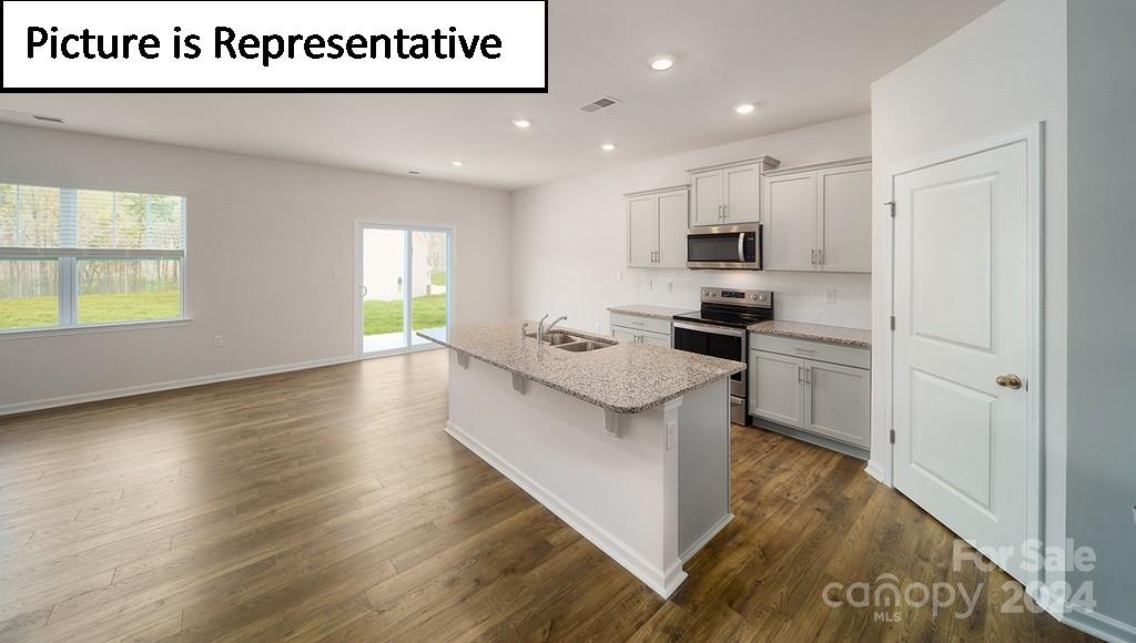 537 Stroupe Road Gastonia, NC 28056 - Photo 5 of 47 a kitchen with stainless steel appliances granite countertop a stove a sink and a refrigerator
