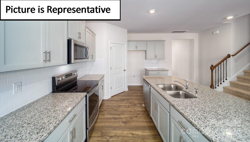 537 Stroupe Road Gastonia, NC 28056 - Photo 8 of 47 a kitchen with granite countertop a sink a counter top space stainless steel appliances and cabinets