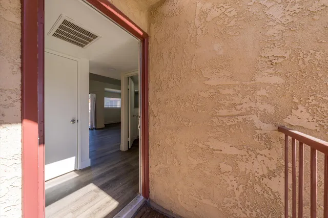 a view of hallway with wooden floor