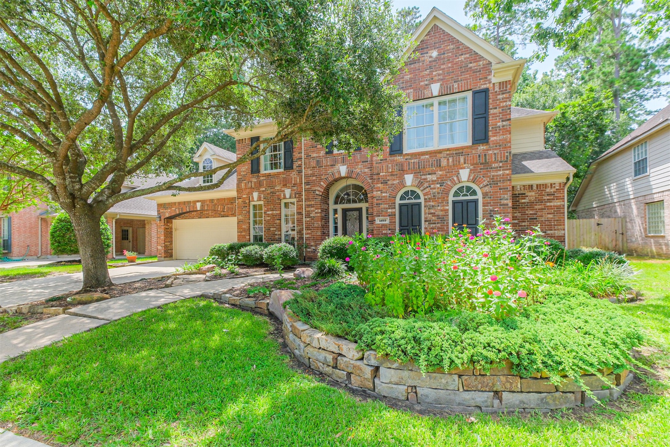 14919 Codys Run Cypress, TX 77429 - Photo 3 of 32 Exceptional curb appeal in one of Cypress' most desirable golf course communities. Mature trees, manicured landscaping, raised stone flower beds, and a classic brick exterior welcome you home, while the quiet cul-de-sac location adds both privacy and charm.