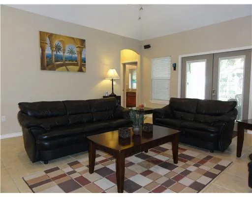 a living room with a couch and paintings on the wall