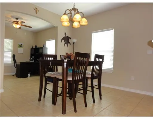 a view of a dining room with furniture and chandelier
