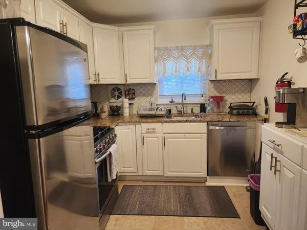 a kitchen with a sink stainless steel appliances and cabinets