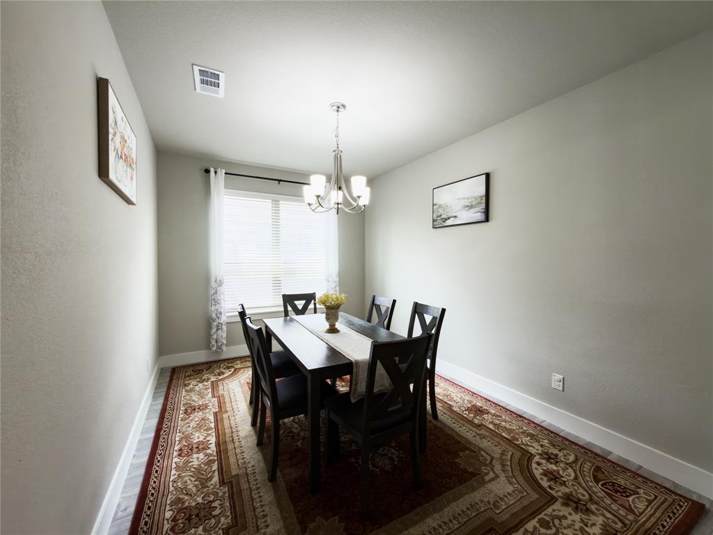 113 Nathan Drive Princeton, TX 75407 - Photo 11 of 40 a view of a dining room with furniture and chandelier
