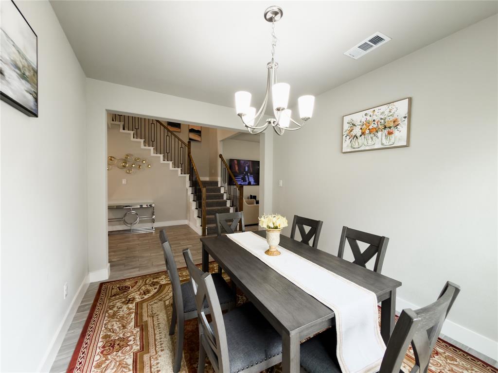 113 Nathan Drive Princeton, TX 75407 - Photo 12 of 40 a view of a dining room with furniture and wooden floor