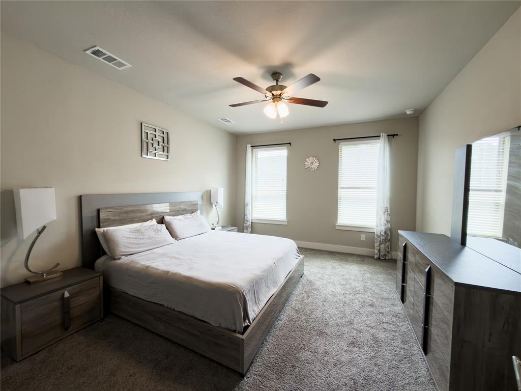 113 Nathan Drive Princeton, TX 75407 - Photo 13 of 40 a bedroom with a bed desk and a window