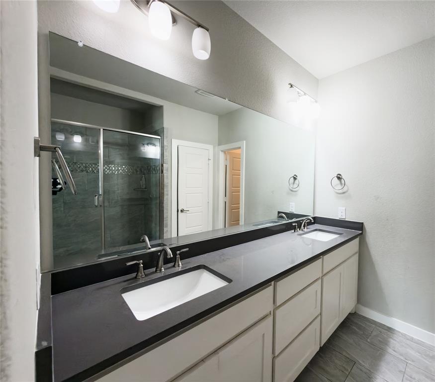 113 Nathan Drive Princeton, TX 75407 - Photo 16 of 40 a bathroom with a sink and a mirror