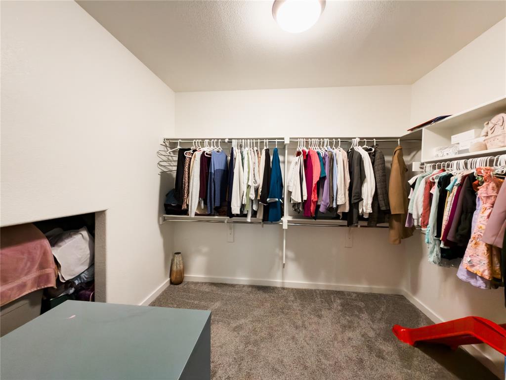 113 Nathan Drive Princeton, TX 75407 - Photo 18 of 40 a view of walk in closet with clothes and shoes