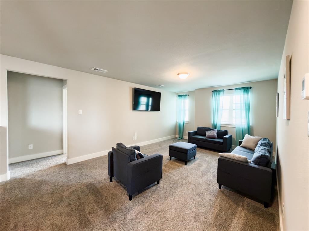 113 Nathan Drive Princeton, TX 75407 - Photo 19 of 40 a living room with furniture and wooden floor