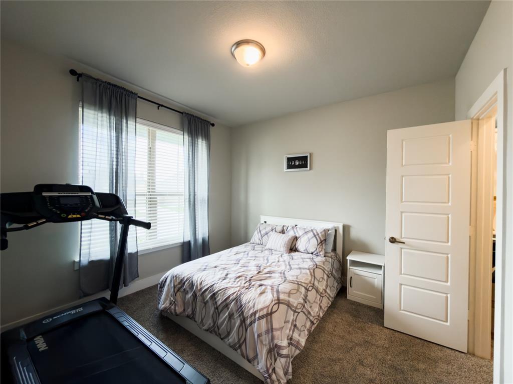 113 Nathan Drive Princeton, TX 75407 - Photo 22 of 40 a bedroom with a bed and a window