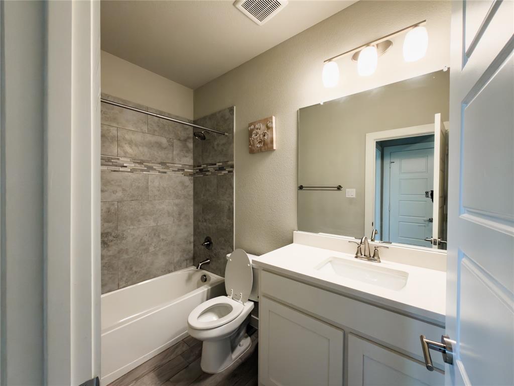 113 Nathan Drive Princeton, TX 75407 - Photo 24 of 40 a bathroom with a sink a toilet and shower