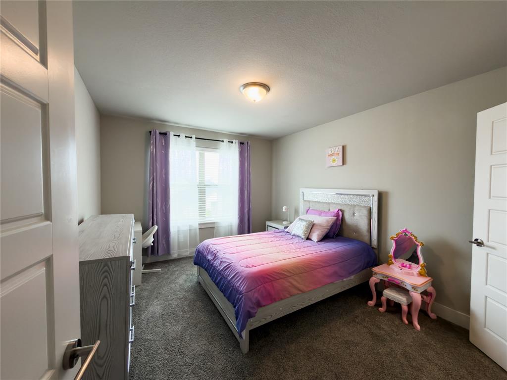 113 Nathan Drive Princeton, TX 75407 - Photo 25 of 40 a bedroom with a bed and a window