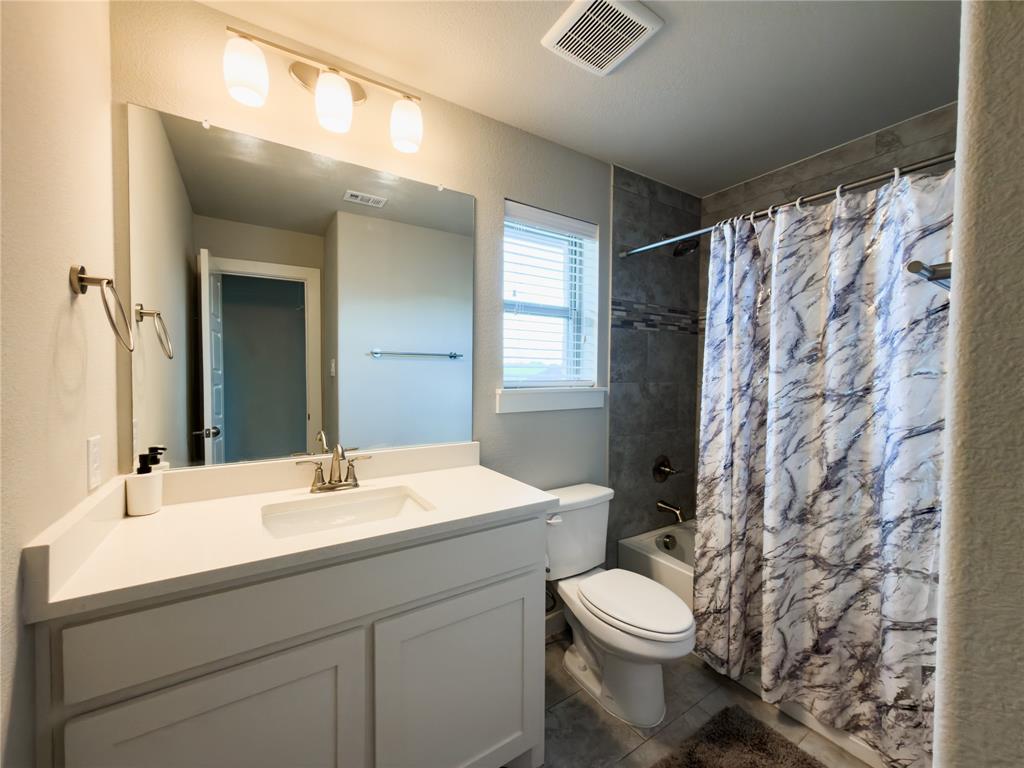 113 Nathan Drive Princeton, TX 75407 - Photo 26 of 40 a bathroom with a sink a toilet and shower