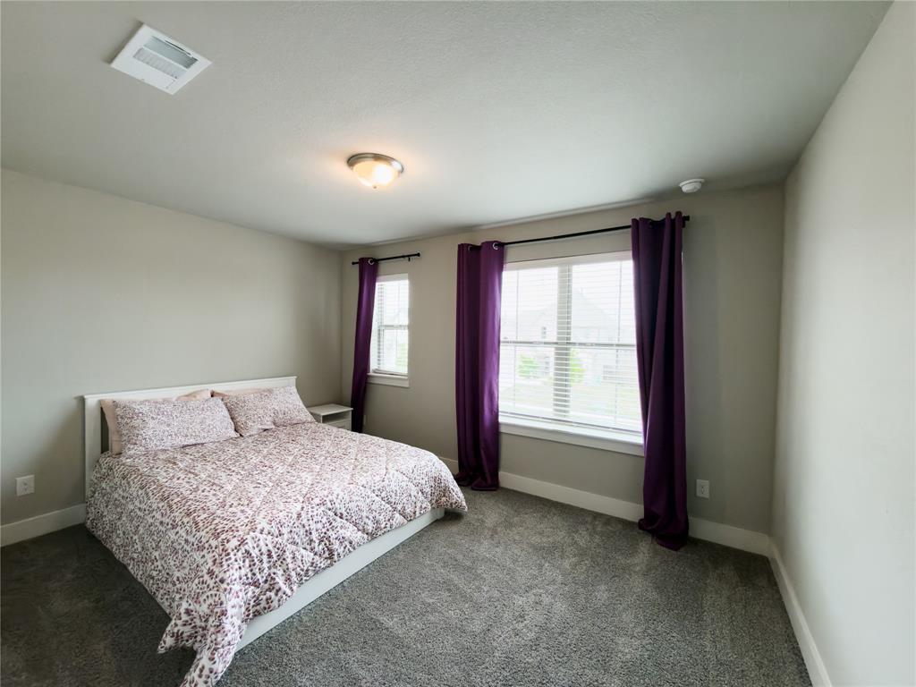 113 Nathan Drive Princeton, TX 75407 - Photo 27 of 40 a bedroom with a large bed and a window