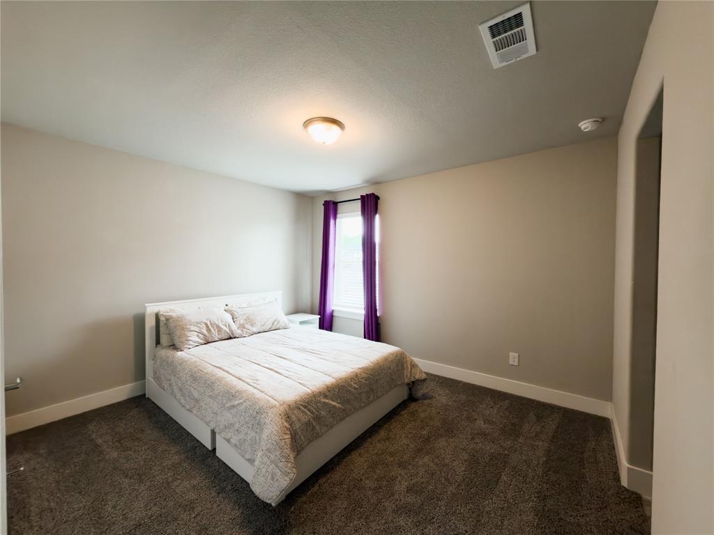 113 Nathan Drive Princeton, TX 75407 - Photo 29 of 40 a bedroom with a bed and a window