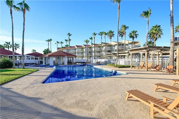 a view of a swimming pool with a lawn chairs