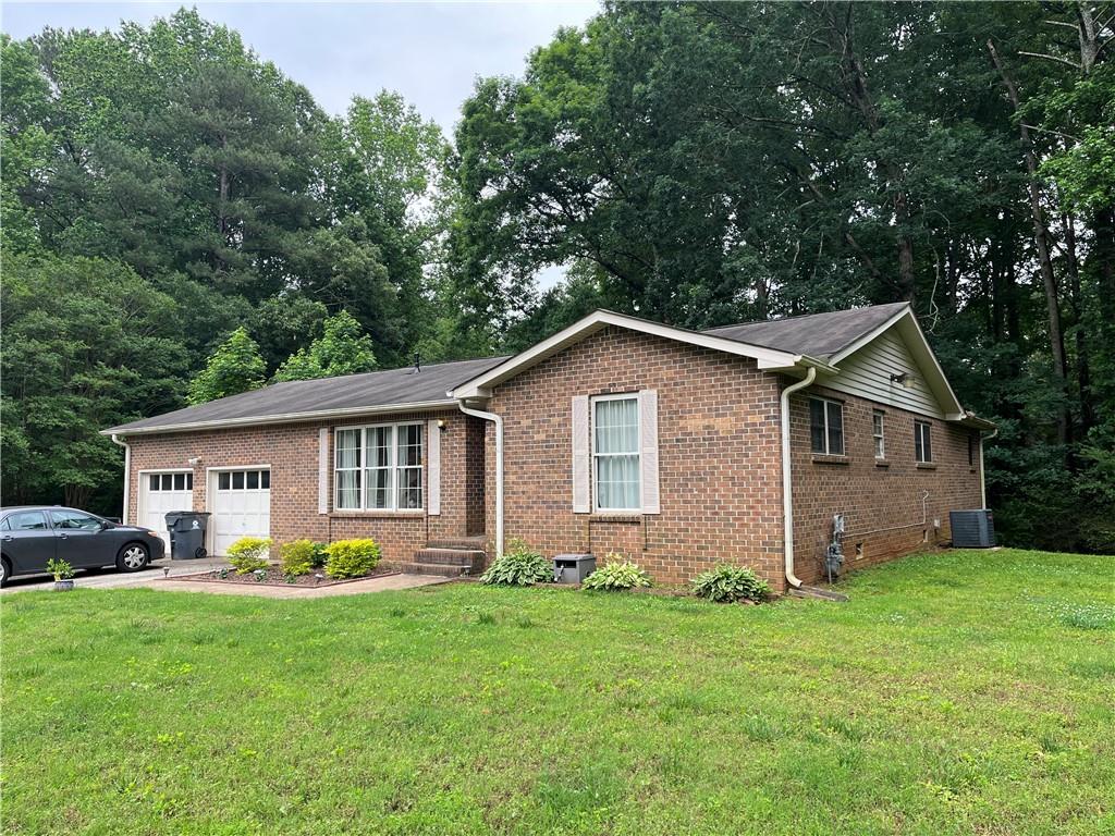 8025 Tupelo Trail Jonesboro, GA 30236 - Photo 1 of 1 a front view of house with yard and green space