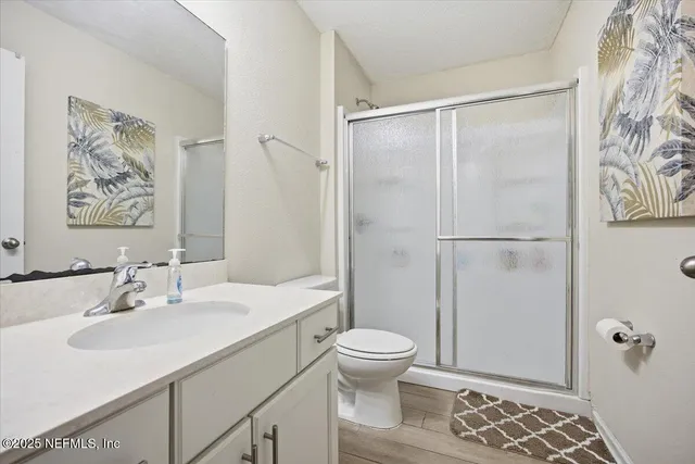 a bathroom with a sink toilet and shower