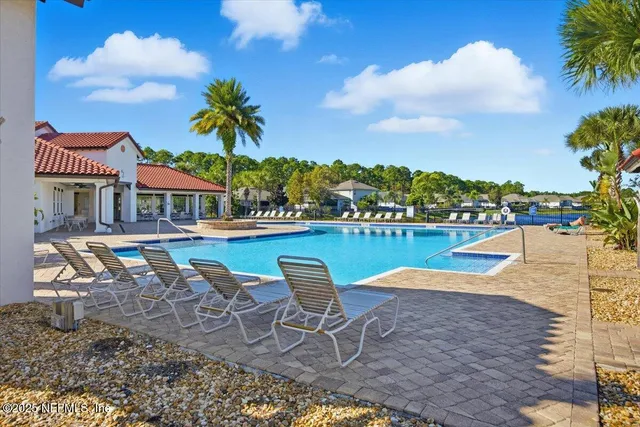 a swimming pool with outdoor seating and yard