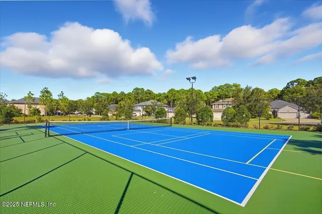 a view of an outdoor space and tennis court