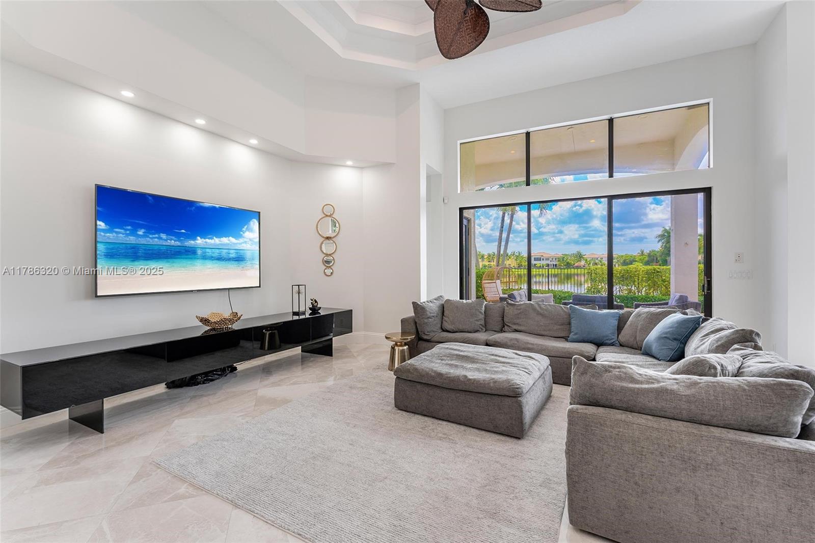 17937 Villa Club Way Boca Raton, FL 33496 - Photo 11 of 41 a living room with furniture a large window and a flat screen tv