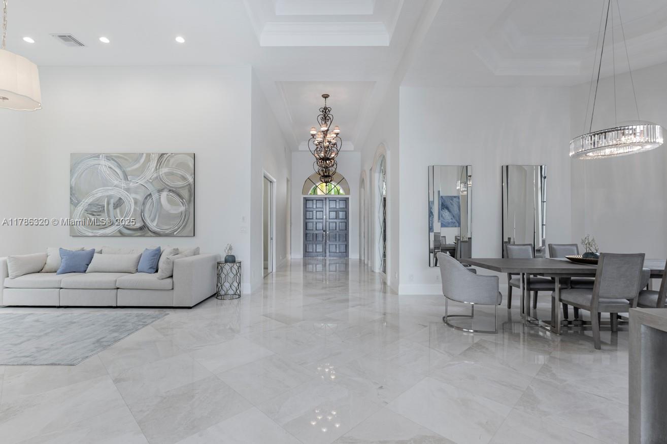 17937 Villa Club Way Boca Raton, FL 33496 - Photo 14 of 41 a living room with furniture a chandelier and a painting
