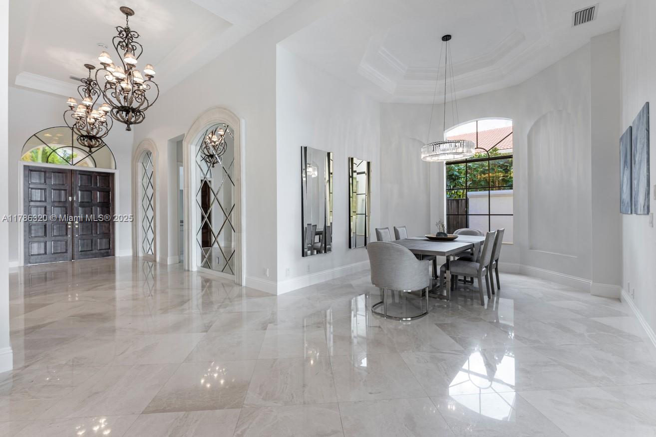 17937 Villa Club Way Boca Raton, FL 33496 - Photo 15 of 41 a view of a dining room with furniture a chandelier and window