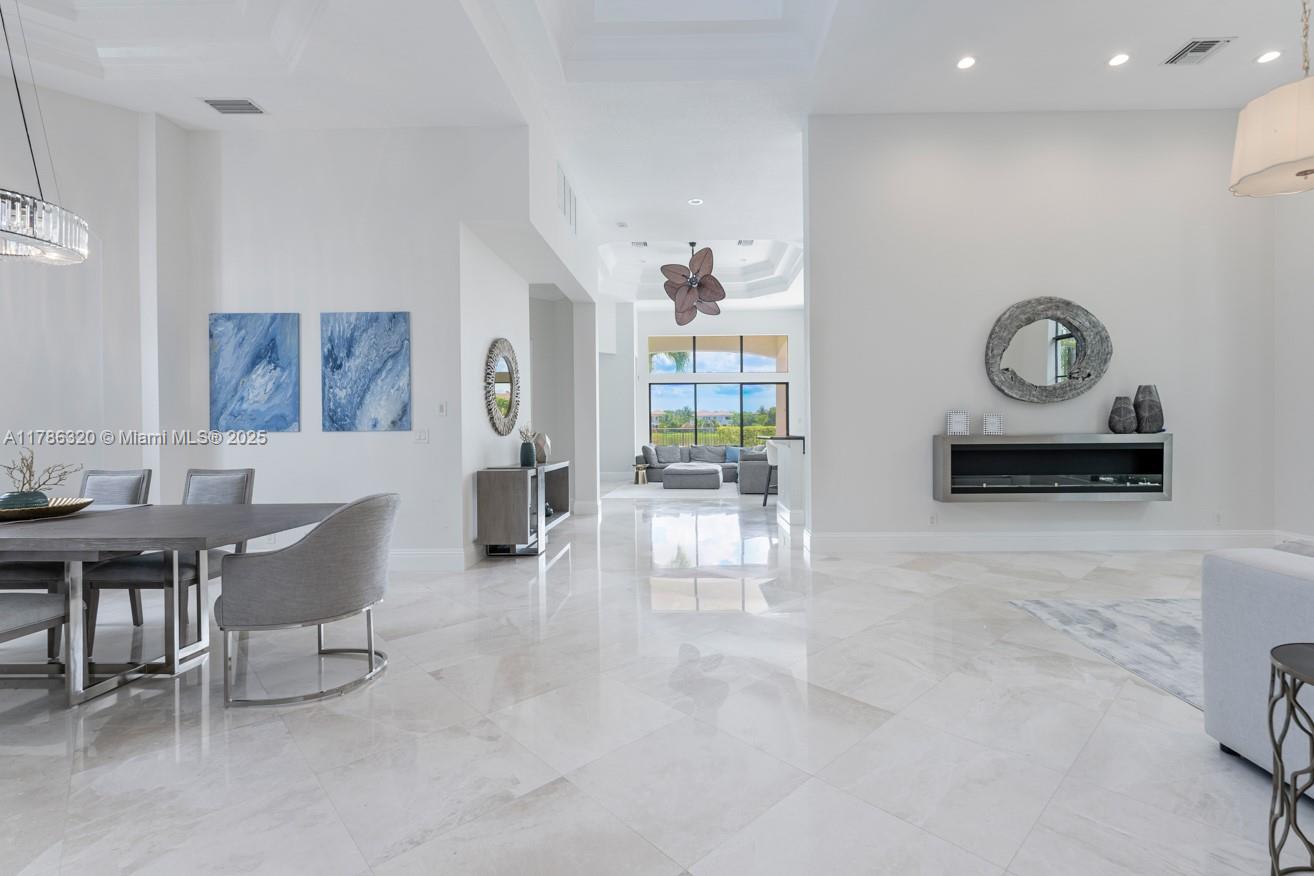 17937 Villa Club Way Boca Raton, FL 33496 - Photo 16 of 41 a living room with furniture a rug and a wall painting