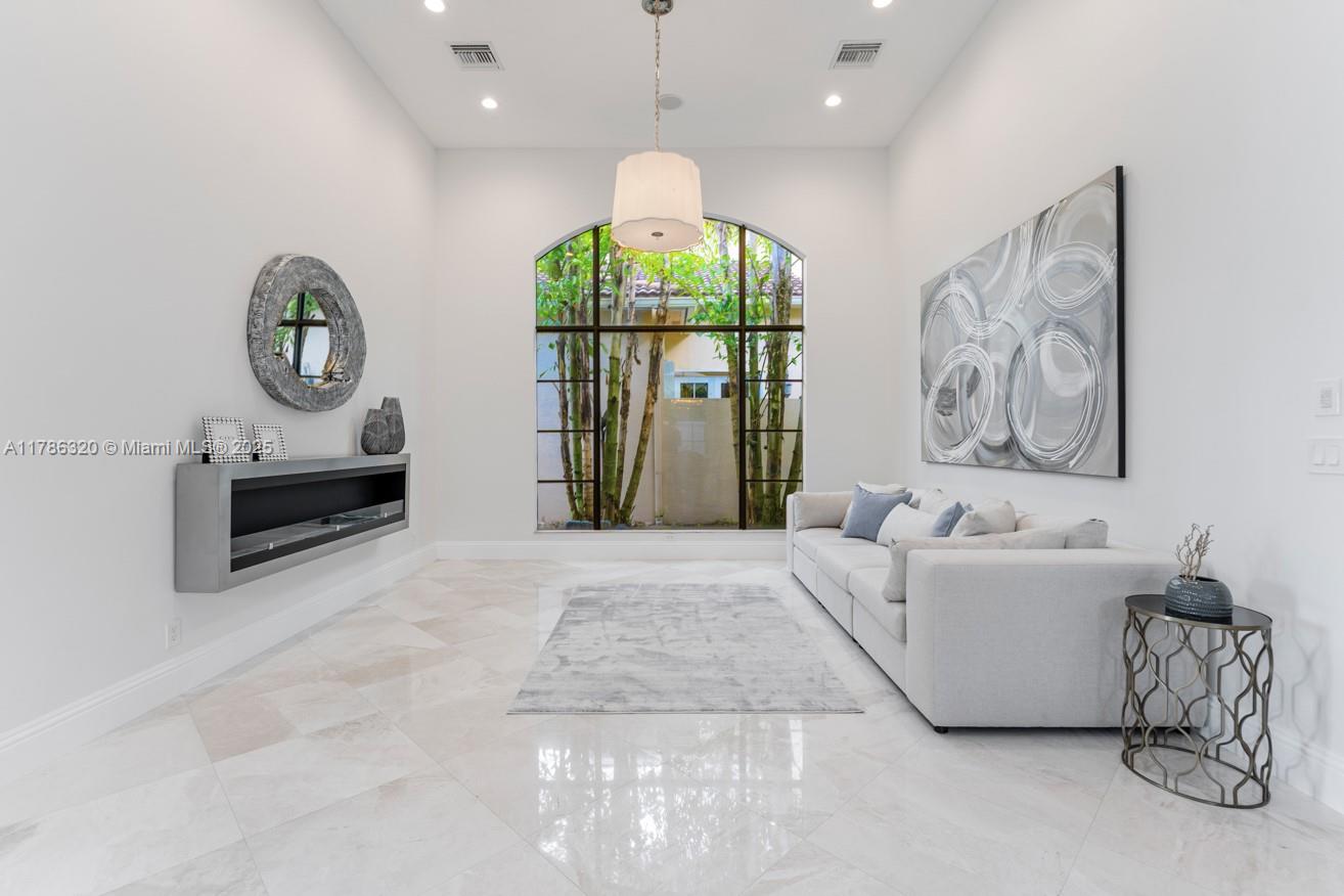 17937 Villa Club Way Boca Raton, FL 33496 - Photo 17 of 41 a living room with a couch and a chandelier