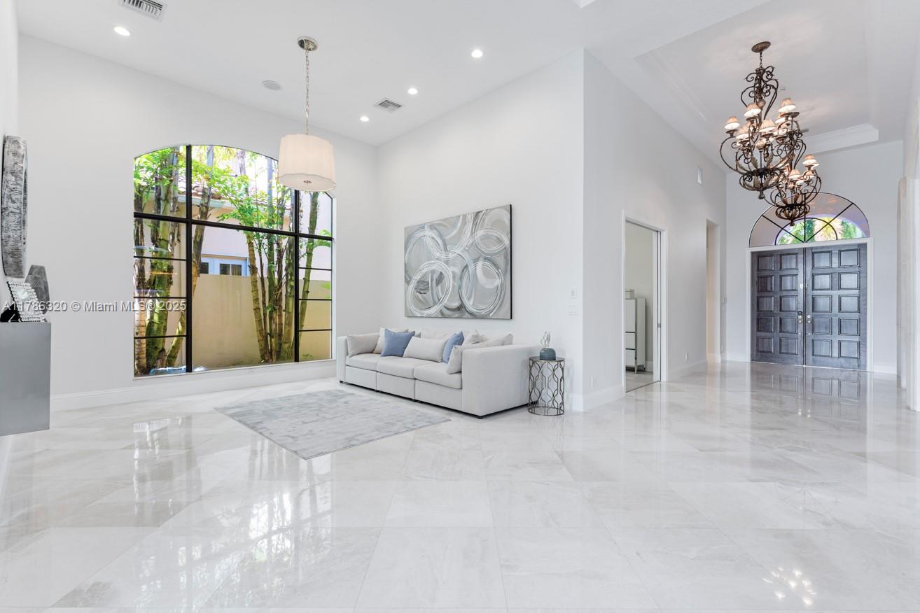 17937 Villa Club Way Boca Raton, FL 33496 - Photo 18 of 41 a spacious bedroom with a large bed and a chandelier