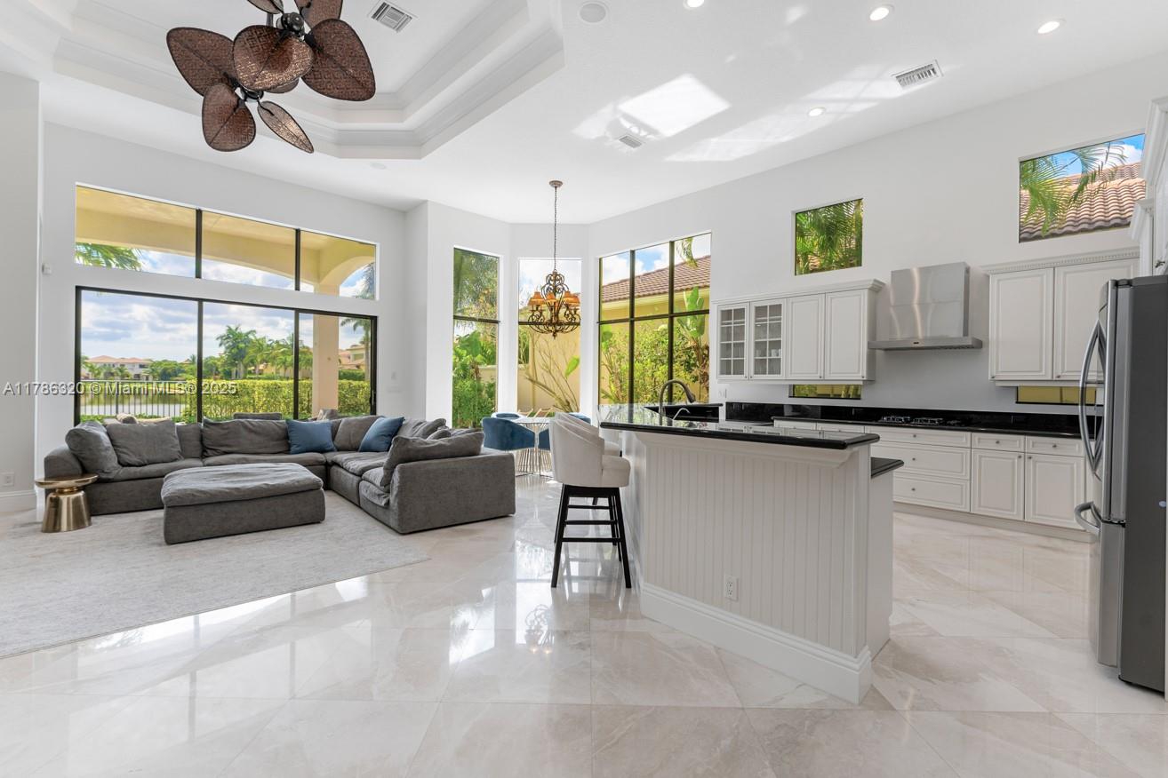 17937 Villa Club Way Boca Raton, FL 33496 - Photo 19 of 41 a living room with kitchen island furniture and a large window