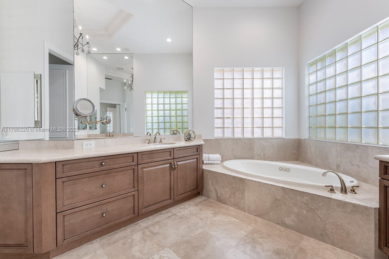 17937 Villa Club Way Boca Raton, FL 33496 - Photo 24 of 41 a spacious bathroom with a granite countertop tub sink and mirror