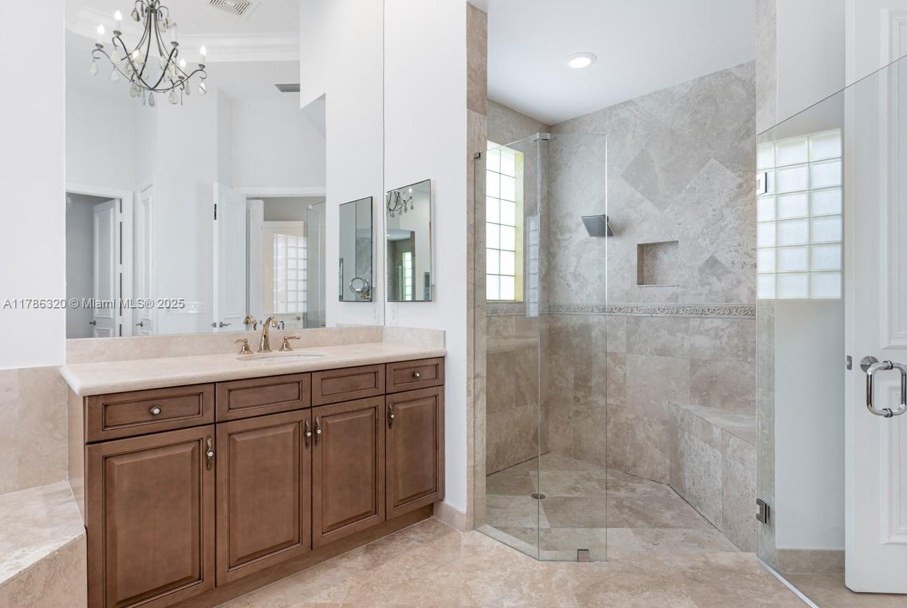 17937 Villa Club Way Boca Raton, FL 33496 - Photo 25 of 41 a spacious bathroom with a shower sink and mirror