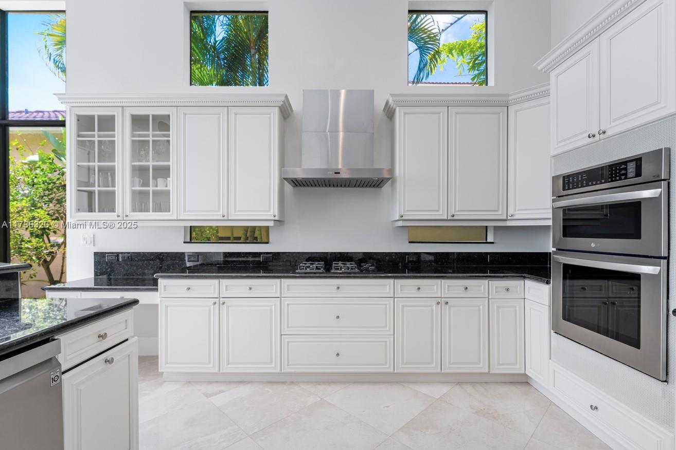 17937 Villa Club Way Boca Raton, FL 33496 - Photo 8 of 41 a kitchen with stainless steel appliances granite countertop white cabinets a window and a sink