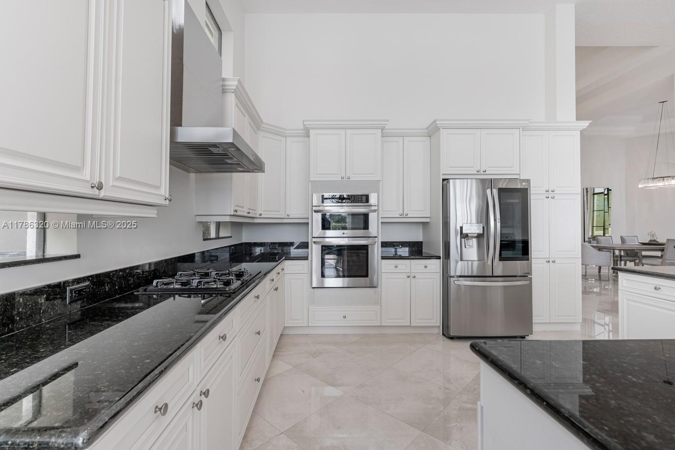 17937 Villa Club Way Boca Raton, FL 33496 - Photo 9 of 41 a large kitchen with stainless steel appliances granite countertop a stove a sink and a refrigerator