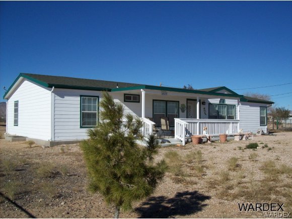 4029 Canelo Road Golden Valley, AZ 86413 - Photo 1 of 15 a house with trees in the background