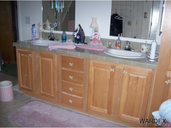 4029 Canelo Road Golden Valley, AZ 86413 - Photo 11 of 15 a bathroom with a double vanity sink and a mirror