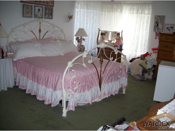 4029 Canelo Road Golden Valley, AZ 86413 - Photo 13 of 15 a bed sitting in a bedroom next to a window with pc on the table