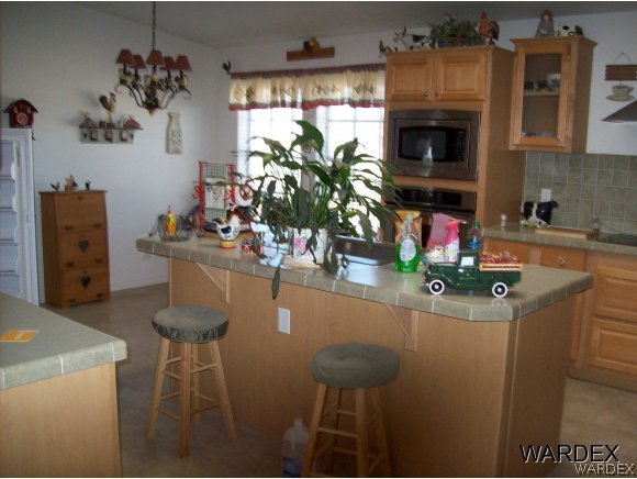 4029 Canelo Road Golden Valley, AZ 86413 - Photo 4 of 15 a dining room with furniture a chandelier and a fireplace