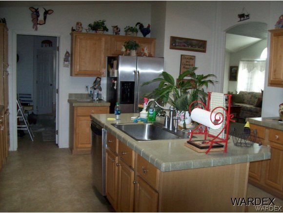 4029 Canelo Road Golden Valley, AZ 86413 - Photo 5 of 15 a kitchen with stainless steel appliances granite countertop a sink and a refrigerator