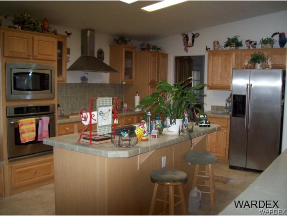 4029 Canelo Road Golden Valley, AZ 86413 - Photo 6 of 15 a kitchen with stainless steel appliances granite countertop a refrigerator and a stove top oven