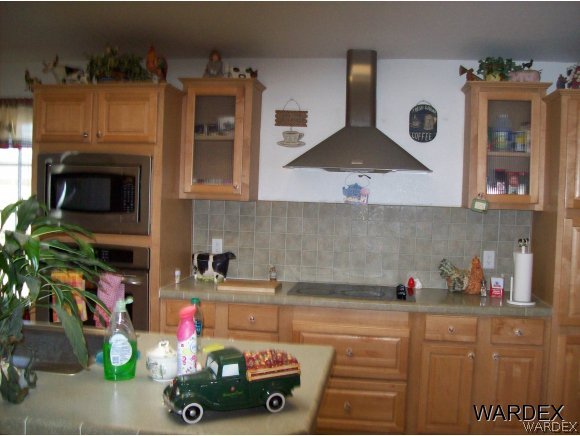 4029 Canelo Road Golden Valley, AZ 86413 - Photo 7 of 15 a kitchen with a microwave a stove and cabinets