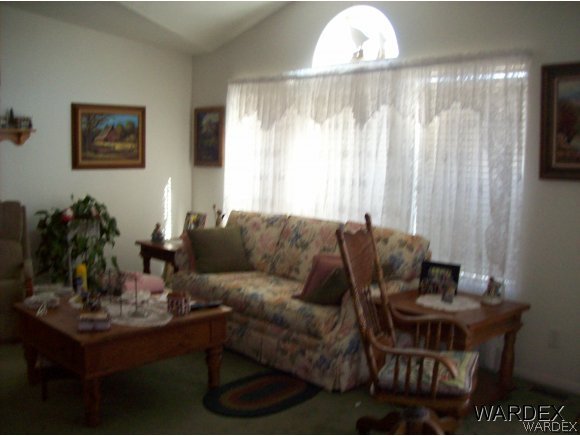 4029 Canelo Road Golden Valley, AZ 86413 - Photo 8 of 15 a living room with furniture and a chandelier