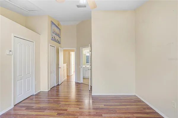 a view of an empty room with wooden floor