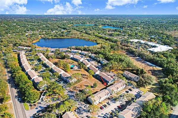 an aerial view of residential houses with outdoor space and river