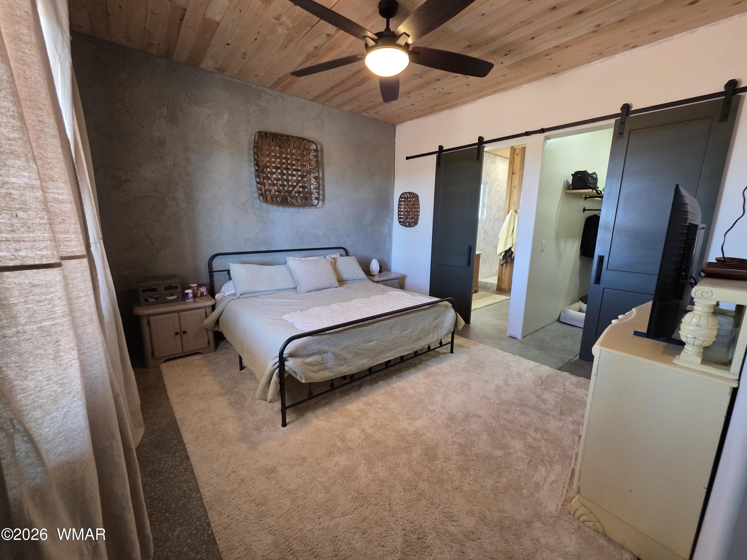 5057 Churchill Road Snowflake, AZ 85937 - Photo 39 of 115 a spacious bedroom with a bed and a flat screen tv