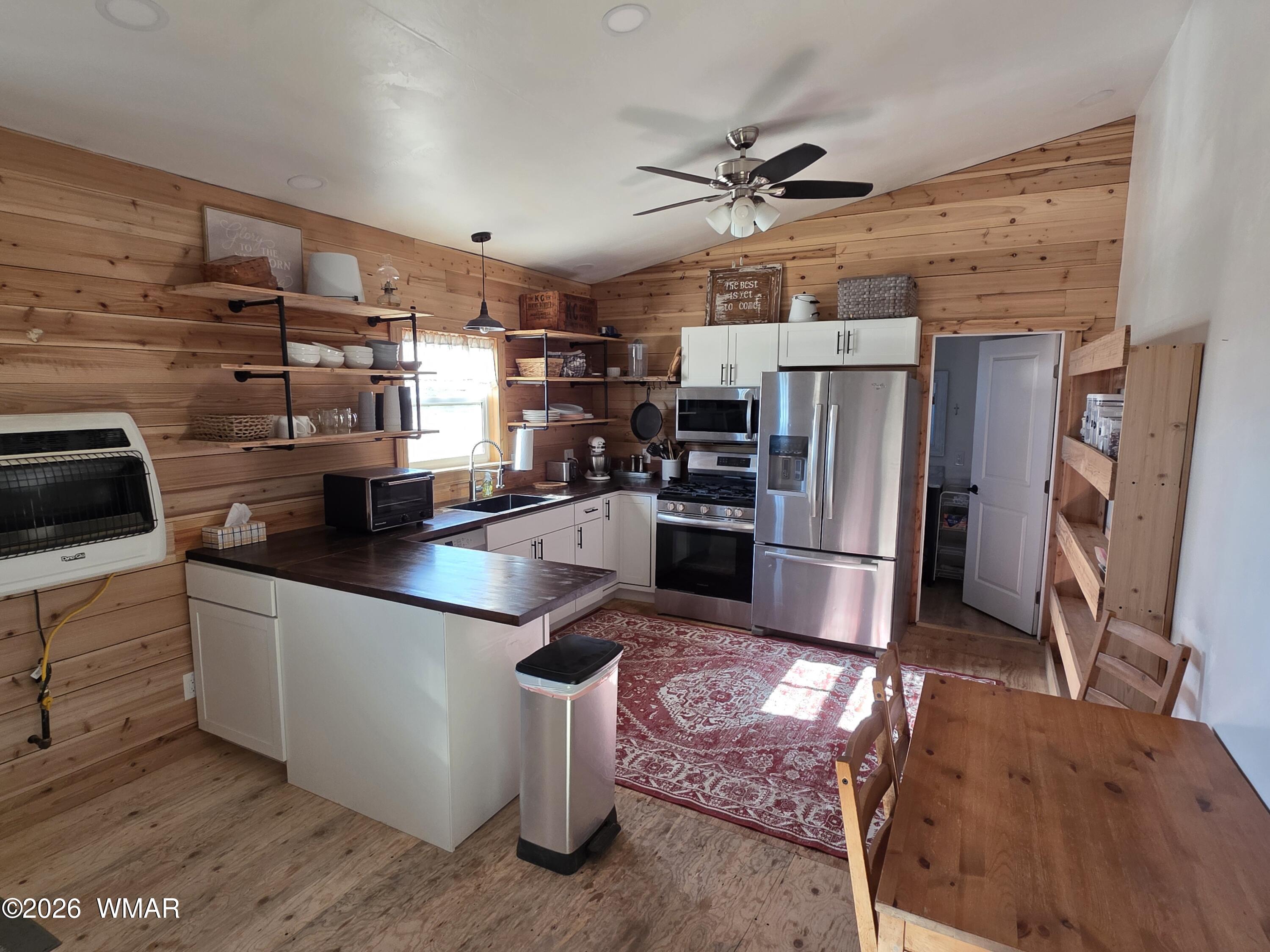 5057 Churchill Road Snowflake, AZ 85937 - Photo 73 of 115 a kitchen with stainless steel appliances granite countertop a refrigerator a stove and a sink